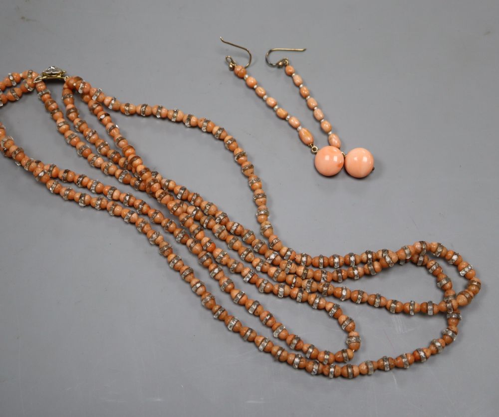 A triple strand split coral bead necklace with paste spacers and rose cut diamond set 18ct clasp & pair of coral earrings.